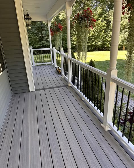 Refaced farmer's porch with Fiberon Chai composite decking, Earl Grey border, and white MoistureShield railing with black balusters in Southern New Hampshire