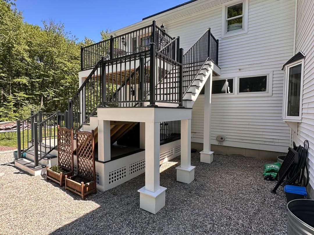 Rear view of a two-level deck showing structural posts and skirted under-deck space