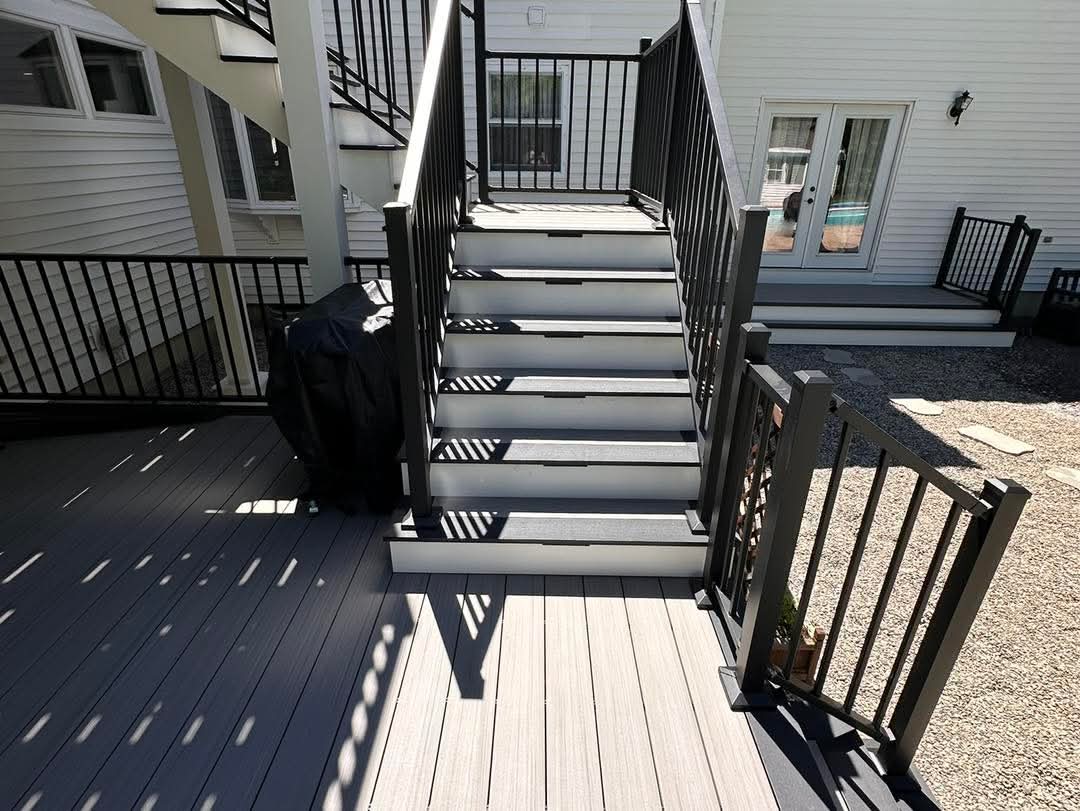 Composite deck stairs with two-tone Glacier and slate decking and black aluminum railings