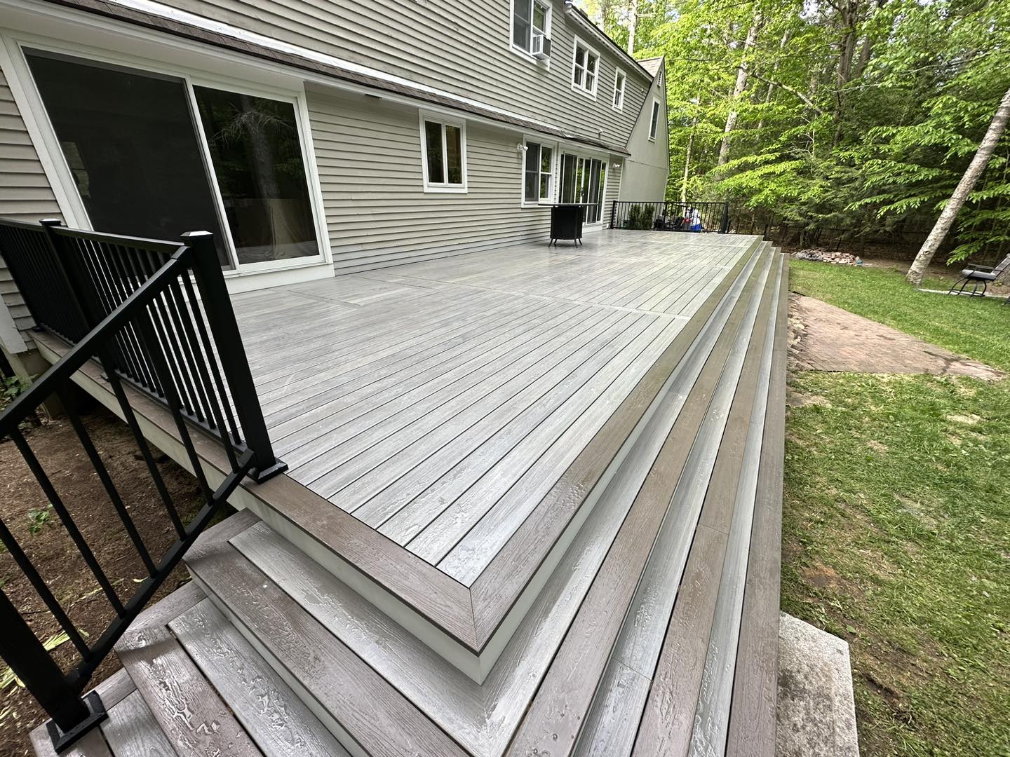Backyard composite deck with seating and railing