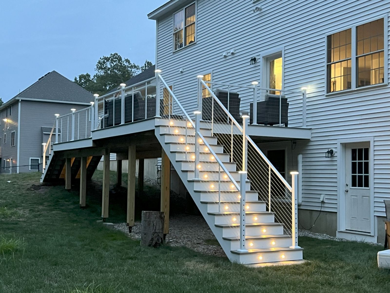 Custom residential deck wrapping the rear of a colonial home