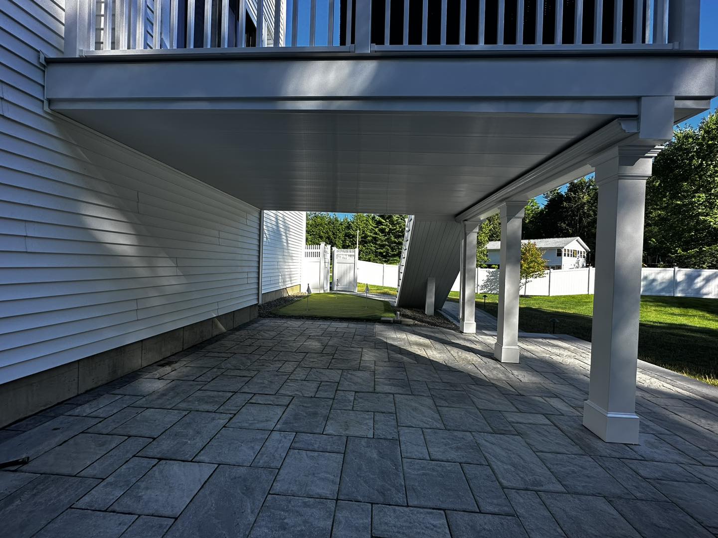 Under-deck ceiling system with paver patio